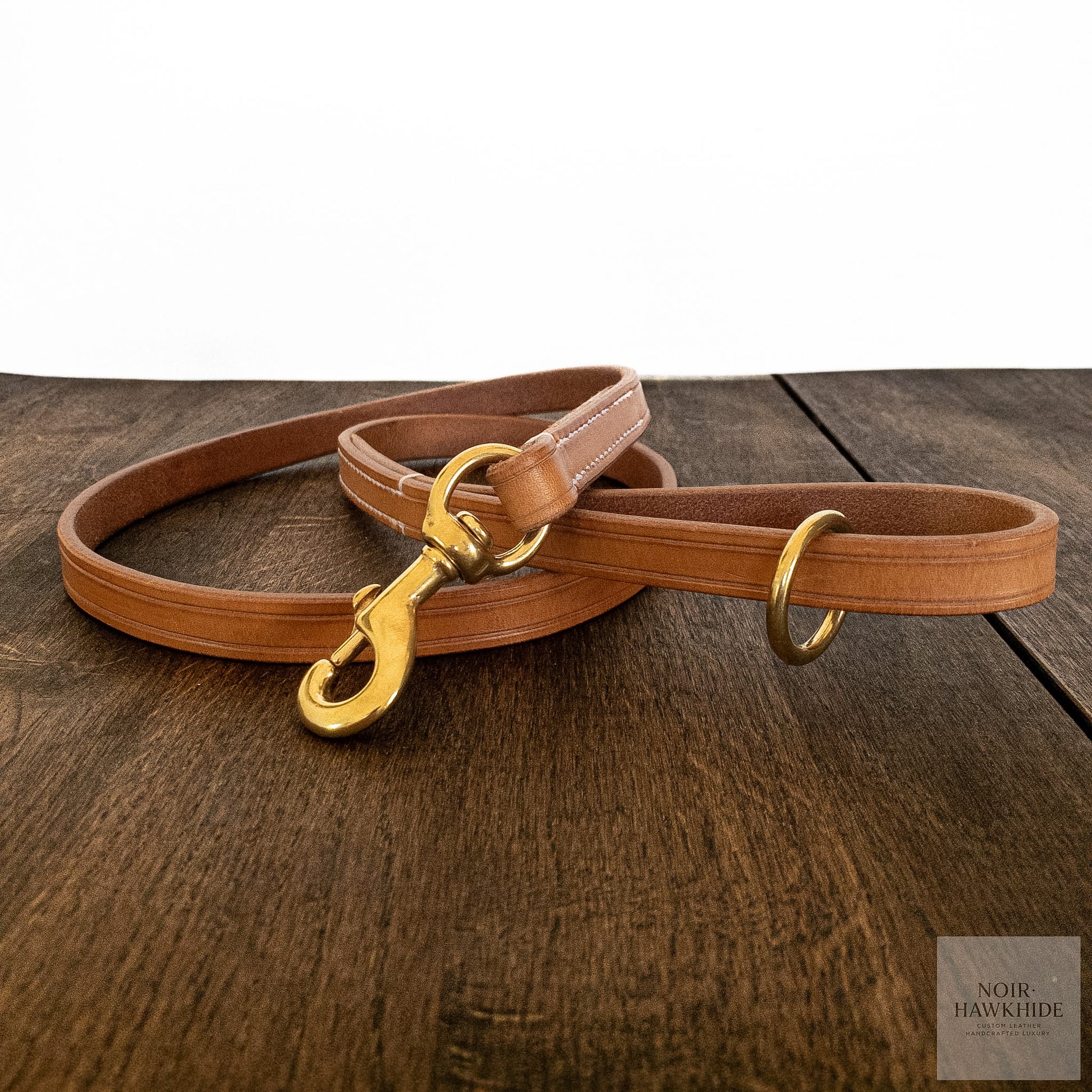 Front view of classic handmade leather dog leash with solid brass hardware.