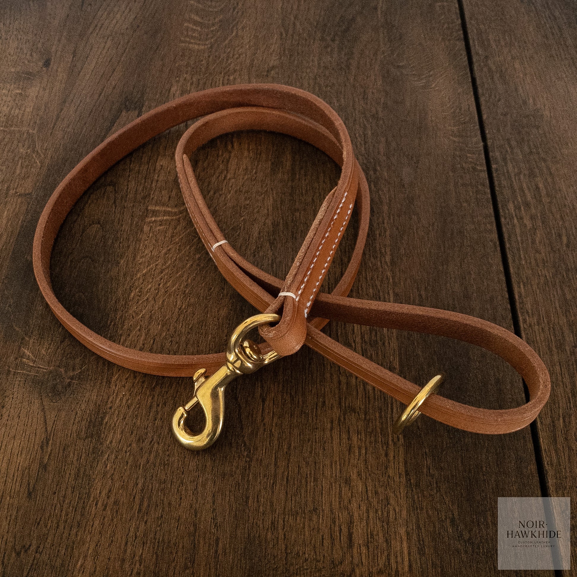 Top view of classic handmade leather dog leash with solid brass hardware.