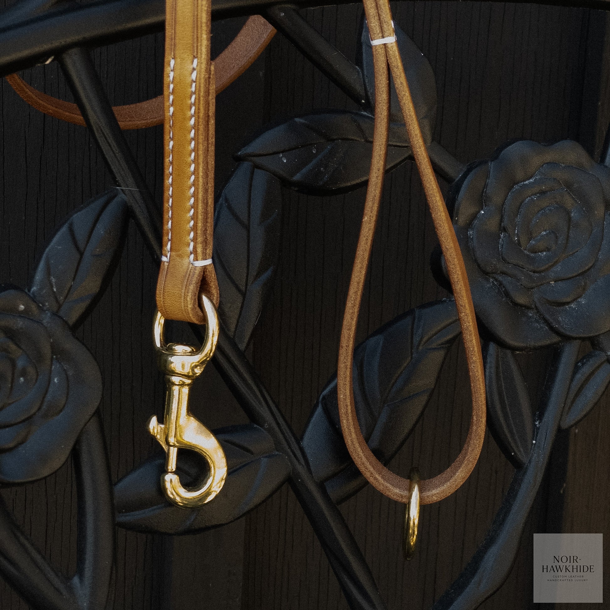 Solid brass snap hook attached to a handmade leather dog leash.