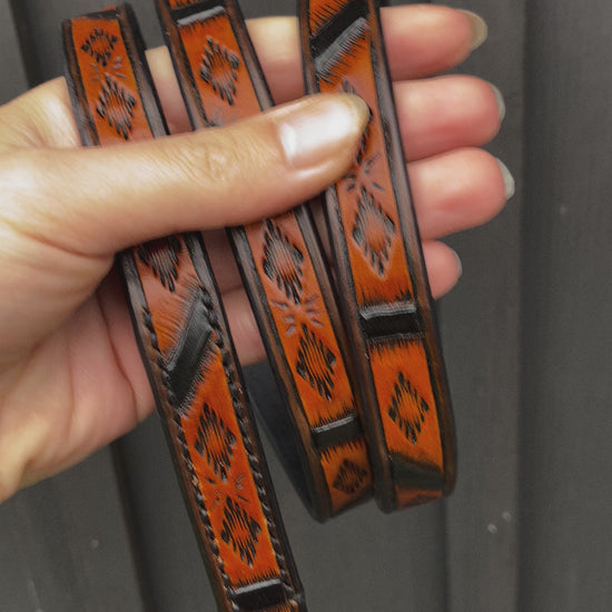 Close-up video of handmade Western Geometric leather dog leash with hand-tooled pattern, black accents and Spanish Brown finish