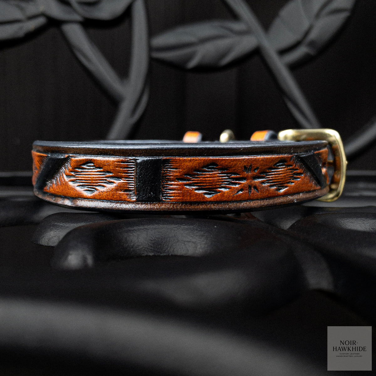 Close-up of hand-tooled geometric pattern on a Spanish Brown leather dog collar with black details